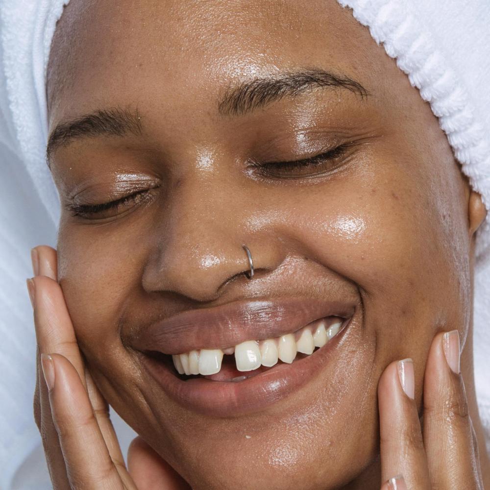 Close up of a woman smiling with healthy glowing skin