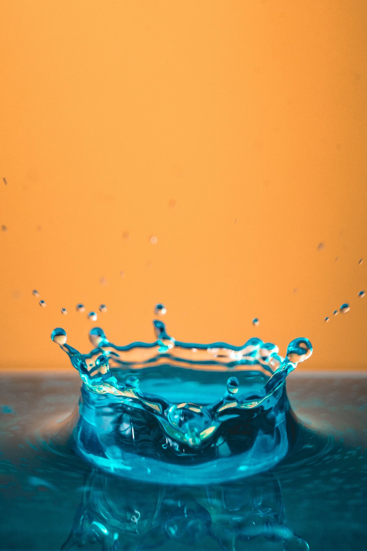 Cleanest filtered water splash from rainley bossa shower filter against an orange background